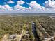 Expansive aerial view showcasing the property's waterfront location along a serene river surrounded by lush greenery at 27385 Neaptide Dr, Punta Gorda, FL 33983