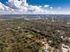 Aerial shot of the property highlighting well-maintained landscaping, waterfront access, and the surrounding lush greenery at 27385 Neaptide Dr, Punta Gorda, FL 33983