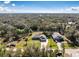 Aerial shot of the property highlighting well-maintained landscaping, a long driveway, and an oversized two car garage at 27385 Neaptide Dr, Punta Gorda, FL 33983