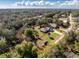 Aerial view of a property with generous lot size, surrounded by lush greenery and clearly marked lot lines at 27385 Neaptide Dr, Punta Gorda, FL 33983