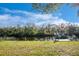 Green backyard leading to a private dock on the canal, offering a serene setting for outdoor living and waterfront access at 27385 Neaptide Dr, Punta Gorda, FL 33983