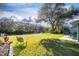 Expansive green backyard featuring a private dock on the canal and a tranquil seating area for relaxation at 27385 Neaptide Dr, Punta Gorda, FL 33983