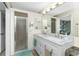 Bathroom boasts a dual sink vanity with a large mirror and a shower stall at 27385 Neaptide Dr, Punta Gorda, FL 33983