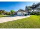 Exterior view of home and its large driveway with a two-car garage at 27385 Neaptide Dr, Punta Gorda, FL 33983