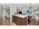 Kitchen island with granite countertop, wood cabinets and stools at 27385 Neaptide Dr, Punta Gorda, FL 33983