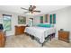 Bedroom features ceiling fan, tile floors and view to outside at 27385 Neaptide Dr, Punta Gorda, FL 33983