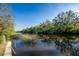 Scenic water view featuring lush greenery, calm water, and serene ambiance at 27385 Neaptide Dr, Punta Gorda, FL 33983