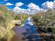 Picturesque view of the river with boat dock, serene waters reflecting the sky, and lush vegetation along the banks at 27385 Neaptide Dr, Punta Gorda, FL 33983