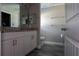 Tastefully designed bathroom with a granite vanity, mirror, and modern fixtures at 342 Sweetwater Dr, Rotonda West, FL 33947