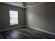 Neutral bedroom with wood-look floors, a ceiling fan, and bright, natural light at 342 Sweetwater Dr, Rotonda West, FL 33947