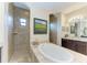 Bathroom features a soaking tub, walk-in shower, dual vanities, and a granite counter at 349 Springview Nw Cir, Port Charlotte, FL 33948