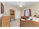 Cozy bedroom featuring wicker furniture, including a bed, desk, and storage cabinet, with a bright window view at 349 Springview Nw Cir, Port Charlotte, FL 33948