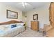 Comfortable bedroom showcasing a daybed, dresser and wicker chair creating a peaceful and inviting space at 349 Springview Nw Cir, Port Charlotte, FL 33948