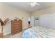 Bright bedroom with a patterned comforter, wood dresser, and natural light creating an inviting space at 349 Springview Nw Cir, Port Charlotte, FL 33948