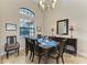 Dining room with high ceilings, large window and elegant chandelier at 349 Springview Nw Cir, Port Charlotte, FL 33948