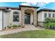 Inviting front entrance featuring stone accents, double doors, and lush landscaping at 349 Springview Nw Cir, Port Charlotte, FL 33948