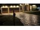 Night view of a home with a brick driveway, prominent mailbox, and a two-car garage at 349 Springview Nw Cir, Port Charlotte, FL 33948