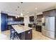 Kitchen with a center island with barstool seating, dark cabinets, and stainless steel appliances at 349 Springview Nw Cir, Port Charlotte, FL 33948