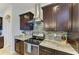 Kitchen with stainless steel appliances, dark cabinets, and tile backsplash at 349 Springview Nw Cir, Port Charlotte, FL 33948