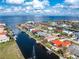 Waterfront single-story home with a private dock and a sparkling waterway view; it features a red metal roof at 35 Sabal Dr, Punta Gorda, FL 33950