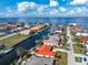 Aerial view of a single-story waterfront home featuring a red metal roof and mature palm trees at 35 Sabal Dr, Punta Gorda, FL 33950