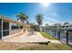 An inviting backyard with a paved patio, perfect for outdoor dining with waterfront views and tropical landscaping at 35 Sabal Dr, Punta Gorda, FL 33950