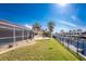 View of the landscaped backyard with screened-in pool and the boat dock with canal at 35 Sabal Dr, Punta Gorda, FL 33950