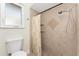 Bathroom with tile walls, tile floors, and a shower with adjustable head and curtain at 35 Sabal Dr, Punta Gorda, FL 33950