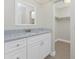 Bathroom vanity with white cabinets, granite counters, and a closet on the side at 35 Sabal Dr, Punta Gorda, FL 33950