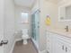 Well-lit bathroom featuring a tiled shower, marble countertops, and modern fixtures at 35 Sabal Dr, Punta Gorda, FL 33950