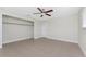 Neutral bedroom with tile flooring, a ceiling fan, bright natural light and closet at 35 Sabal Dr, Punta Gorda, FL 33950