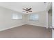 Neutral bedroom with tile flooring, a ceiling fan, and bright natural light from the large windows at 35 Sabal Dr, Punta Gorda, FL 33950