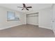 Neutral bedroom with tile flooring, a ceiling fan, and bright natural light with closet at 35 Sabal Dr, Punta Gorda, FL 33950