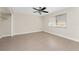 Bedroom featuring tile flooring, a ceiling fan with lights, and a closet with shelves at 35 Sabal Dr, Punta Gorda, FL 33950