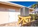 Exterior shot of air conditioner and doorway surrounded by tropical landscaping at 35 Sabal Dr, Punta Gorda, FL 33950