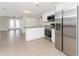 Bright kitchen features stainless steel appliances and white cabinetry, seamlessly flowing into the open floor plan at 35 Sabal Dr, Punta Gorda, FL 33950