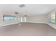 Wide angle view of a large living room with access to the lanai and kitchen at 35 Sabal Dr, Punta Gorda, FL 33950