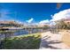 A serene backyard with a view of a sailboat docked along the waterfront, with houses in the background at 35 Sabal Dr, Punta Gorda, FL 33950