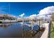 Beautiful waterfront view of the boat dock and neighborhood homes under a sunny, partly cloudy sky at 35 Sabal Dr, Punta Gorda, FL 33950