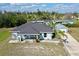 Aerial view of a beautiful home with a detached garage in a serene, tree-lined neighborhood at 3714 Gulfbreeze Ln, Punta Gorda, FL 33950