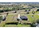 Aerial perspective of a residential home with a private detached garage situated on a grassy lot near town at 3714 Gulfbreeze Ln, Punta Gorda, FL 33950