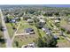 High-angle photograph of a residential neighborhood home and detached garage amid a lush, green landscape at 3714 Gulfbreeze Ln, Punta Gorda, FL 33950