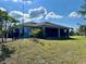 A spacious backyard featuring a screened lanai perfect for outdoor entertaining and relaxation at 3714 Gulfbreeze Ln, Punta Gorda, FL 33950