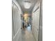 Hallway featuring a crystal light fixture and access to a bathroom at 3714 Gulfbreeze Ln, Punta Gorda, FL 33950