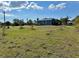 A large yard with sparse landscaping and some trees at 3714 Gulfbreeze Ln, Punta Gorda, FL 33950