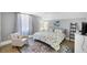 Cozy bedroom featuring a comfortable armchair, patterned rug, and sunny window at 4 Saint Martin Cir, Englewood, FL 34223