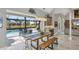 Dining area with views of the pool, screened in lanai, and outdoor living area at 4 Saint Martin Cir, Englewood, FL 34223