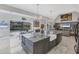 Open kitchen design with marble countertops, oversized island, and views to the pool at 4 Saint Martin Cir, Englewood, FL 34223