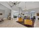 Spacious open-concept living room featuring marble floors, and expansive windows with an adjacent dining area at 4 Saint Martin Cir, Englewood, FL 34223