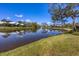 Picturesque view of the serene pond surrounded by lush greenery and well-manicured lawns at 4 Saint Martin Cir, Englewood, FL 34223